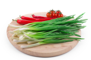 Bunch of green onion on wooden platter.