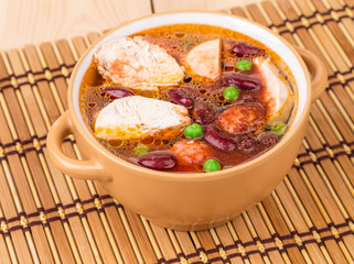 Fresh vegetable soup with sausage.