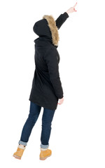 Naklejka premium Back view of pointing young women in parka.