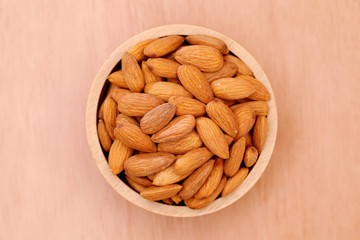 Fresh almonds in a wooden bowl