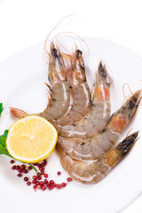 Raw shrimps on white plate.