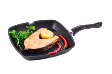 Frying pan with salmon steak.