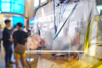 Double exposure manipulation of Business Man using Tablet and bl