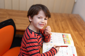 Preschooler genius boy solving math exercise