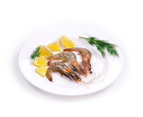 Raw shrimps on plate with lemon