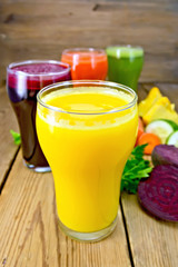 Juice pumpkin and vegetable in glassful on board