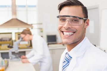 Happy scientist smiling at camera