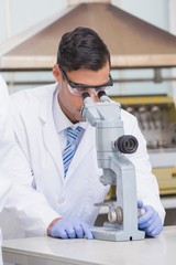 Scientist examining something with the microscope