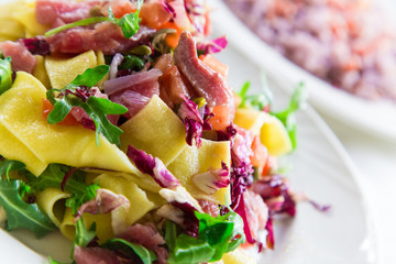 Homemade tagliatelle with fresh tuna served with cherry tomatoes