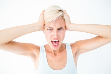 Angry woman screaming and holding her head