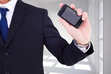 mid section of a businessman typing on his phone