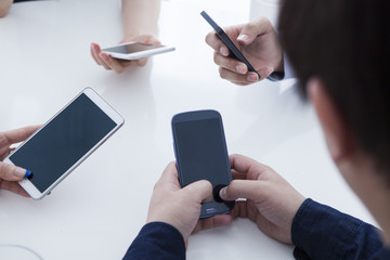 Four businessmen have a cell phone