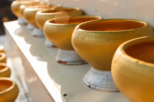 golden buddhist monk alms bowl for people to donate money