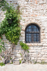 Fototapeta na wymiar Old wooden window on stonewall, Balchik, Bulgaria