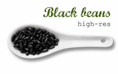 Black beans in white porcelain spoon 