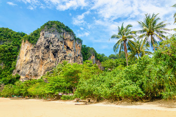 Amazing Railay Beach with mogotes, long tail boat and red kayaks