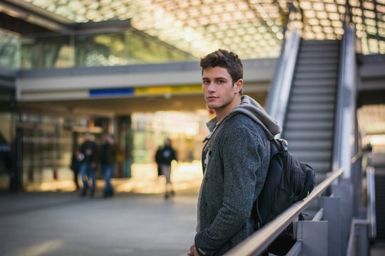 Profile shot of handsome young man inside train station