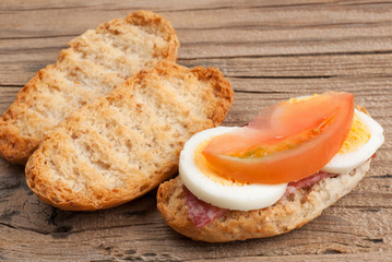 Rusk sandwich with salami, egg and tomato