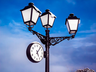 Fototapeta na wymiar Streetlight with clock