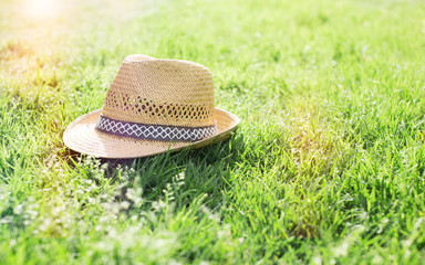 straw hat on grass during summer season
