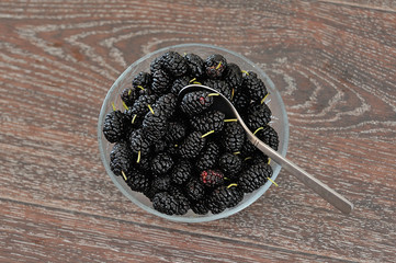 piala in black mulberry pile on a wooden background