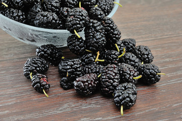 piala in black mulberry pile on a wooden background