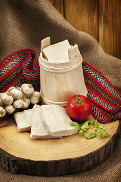 Delicious organic milk cheese in wooden vat