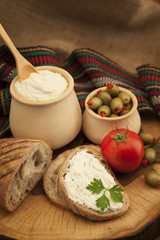 Delicious organic cream milk cheese, olives and home-made bread