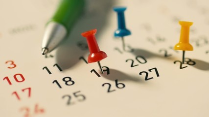 Dolly shot Push pin on a calendar