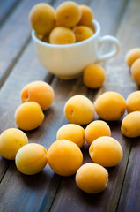 Naklejka na ściany i meble Sweet ripe apricots on wooden table. Selective focus