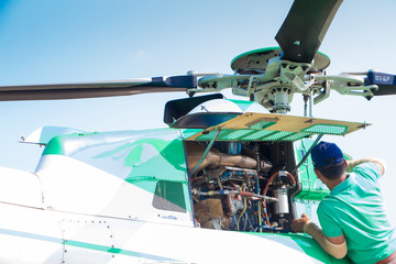 Engineer maintaining a helicopter Engine