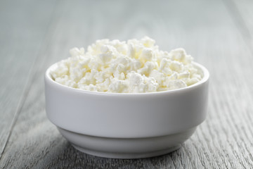 cottage cheese in white bowl on old table