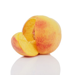 ripe peach with one segment cut out isolated