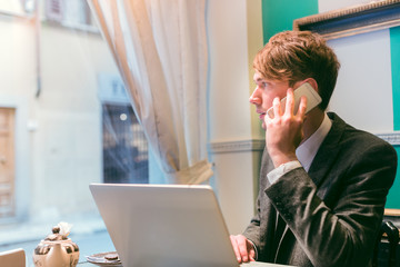 Business man with mobile phone in coffee shop
