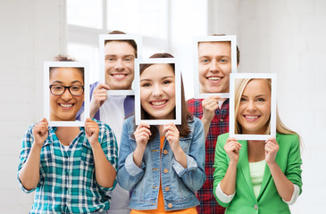 friends or students covering faces with papers