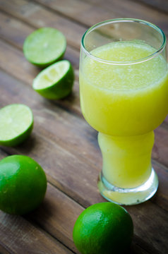 green limes with lime juice in the glass