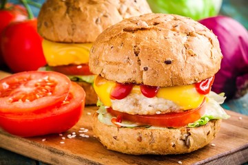 home burgers with fresh vegetables and chicken cutlet closeup