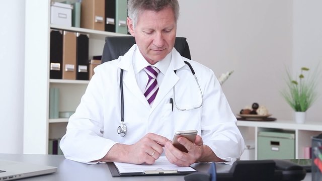 doctor working at the hospital and using a smart phone
