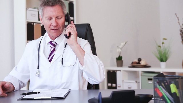 Medical doctor working with laptop in the office and write 
