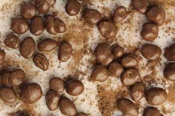 Sprinkled round chocolate balls covered by cocoa powder