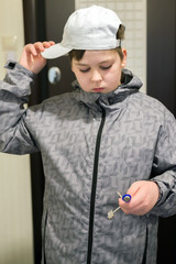 boy standing at  front door of the house