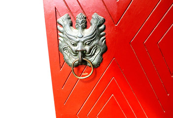 Red Wooden Door Decorated With Bronze Animal Head