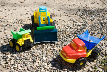 Plastic trucks on the sand