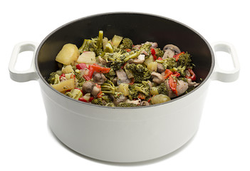 Cooking pot full of vegetables isolated on white background