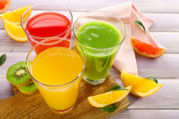 Fresh juices with fruits on wooden table