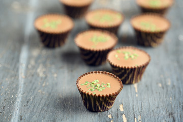 Tasty chocolate candies on wooden table