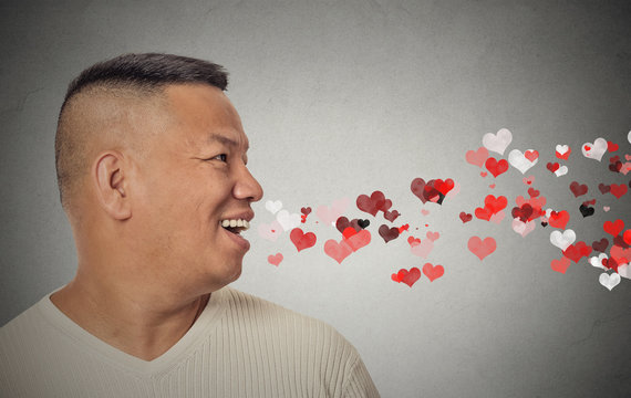 man sending kisses, red hearts coming out of open mouth