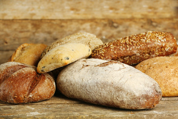 Different fresh bread on old wooden table