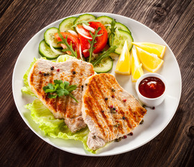 Grilled steaks and vegetable salad