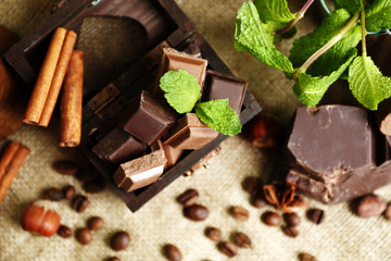Still life with set of chocolate on burlap cloth, closeup
